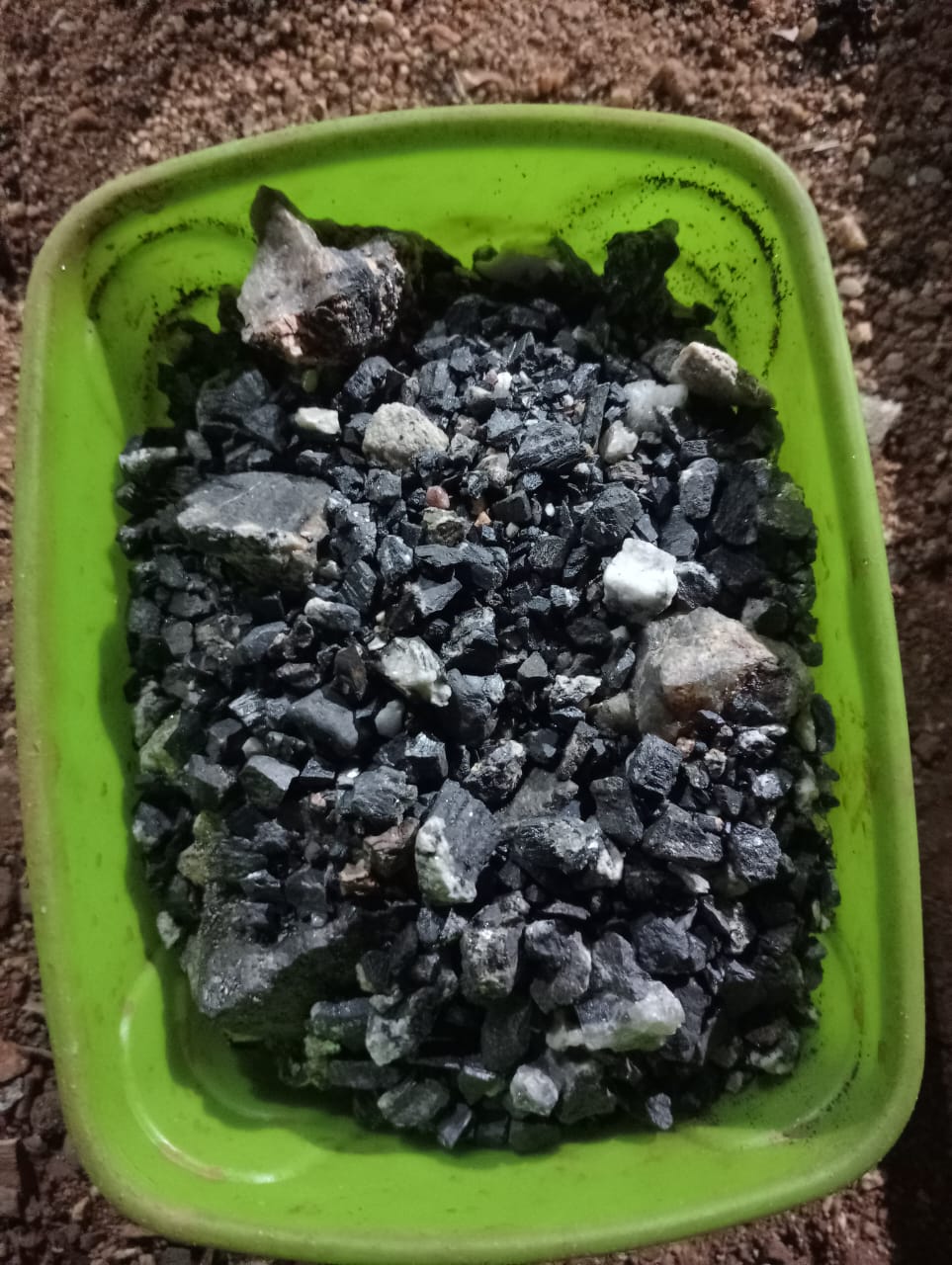 Tantalite ore concentrate at 30 to 38 percent purity, sorted in a sampling tray