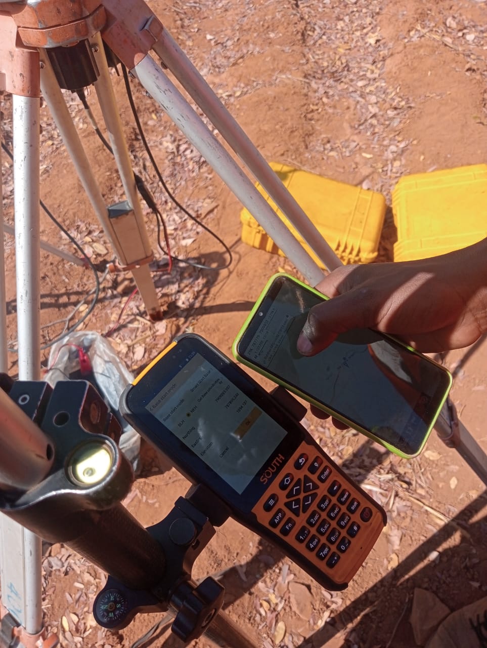 GNSS base station being configured on a tripod, coordinates shown on the controller