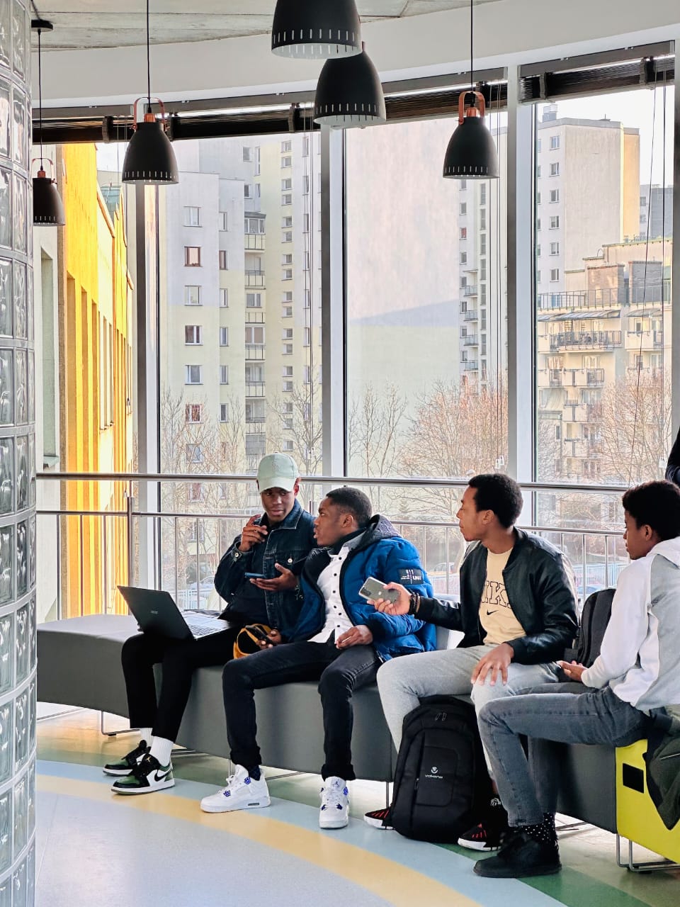 NECTAR-placed students studying together in a campus lounge overlooking Warsaw